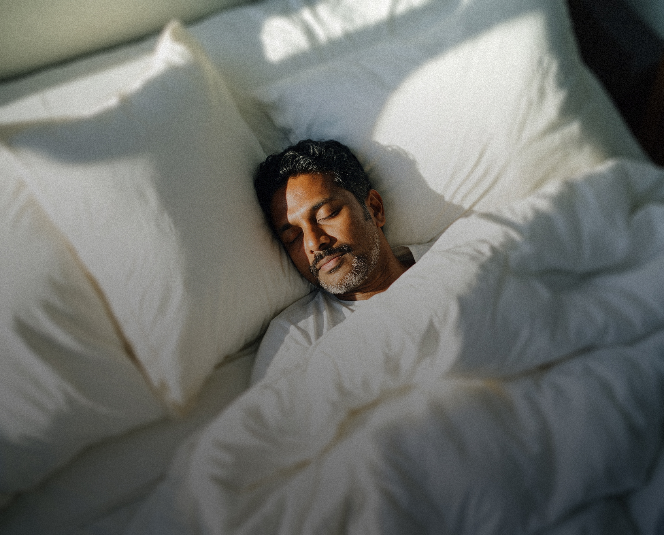 A person sitting quietly in soft light