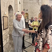 אתי האופטמן לוחצת יד למשתתפת בכנסייה העתיקה בסיור מתחברים לישראל