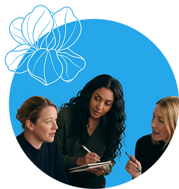 Three women collaborating in a professional workplace wellbeing discussion, framed in a blue circle with an iris illustration