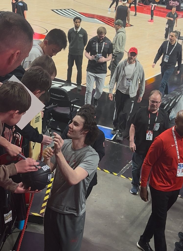 Josh Giddey meeting fans and signing memorabilia