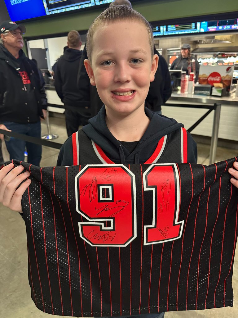Young traveller holding a signed NBA jersey