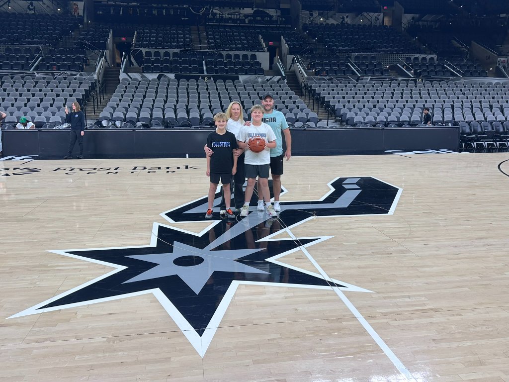 Dream Hoop Tours family group on an NBA court