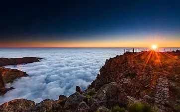 Sunrise above a sea of clouds over the volcanic peaks of Madeira