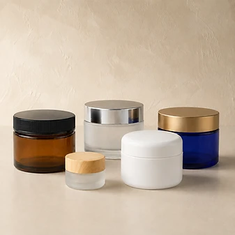 Assorted jars — amber, frosted, white and cobalt glass and plastic