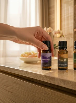 Ashbury's production: a hand placing private-label essential oil bottles on a marble counter