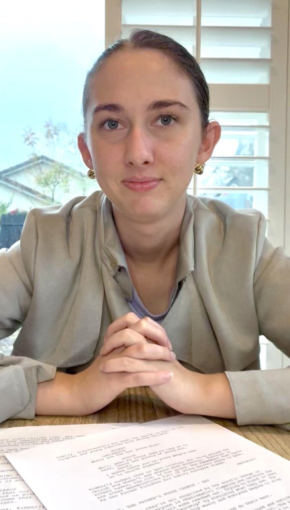 Jacqueline Cyr at her studio table, reviewing a screenplay manuscript