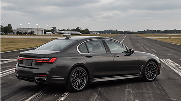 BMW 7 Series sedan angled right on an airfield