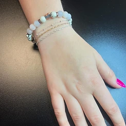 Stacked permanent bracelets with beaded chain, heart charm, and fine gold and silver chains by Oh She Linked