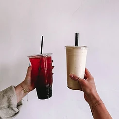 Friends wearing Oh She Linked permanent gold bracelets and rings while toasting drinks at a private party