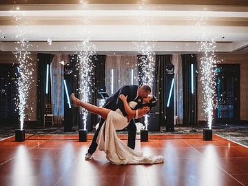 Bride and groom in a dip with sparkler fountains framing the dance floor at their Shenandoah Clubhouse wedding at Turning Stone