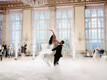 Bride and groom surrounded by dancing on the clouds and cold sparks in the Marriott Syracuse Downtown Grand Ballroom