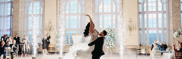 Bride and groom surrounded by dancing on the clouds and cold sparks in the Marriott Syracuse Downtown Grand Ballroom