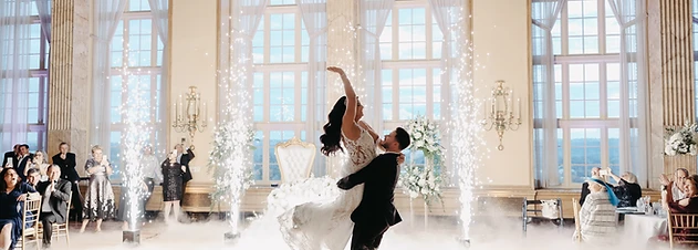 Bride and groom surrounded by dancing on the clouds and cold sparks in the Marriott Syracuse Downtown Grand Ballroom