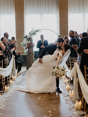 Brittany and Ryan's ceremony dip-kiss at the end of the aisle in the Persian Terrace