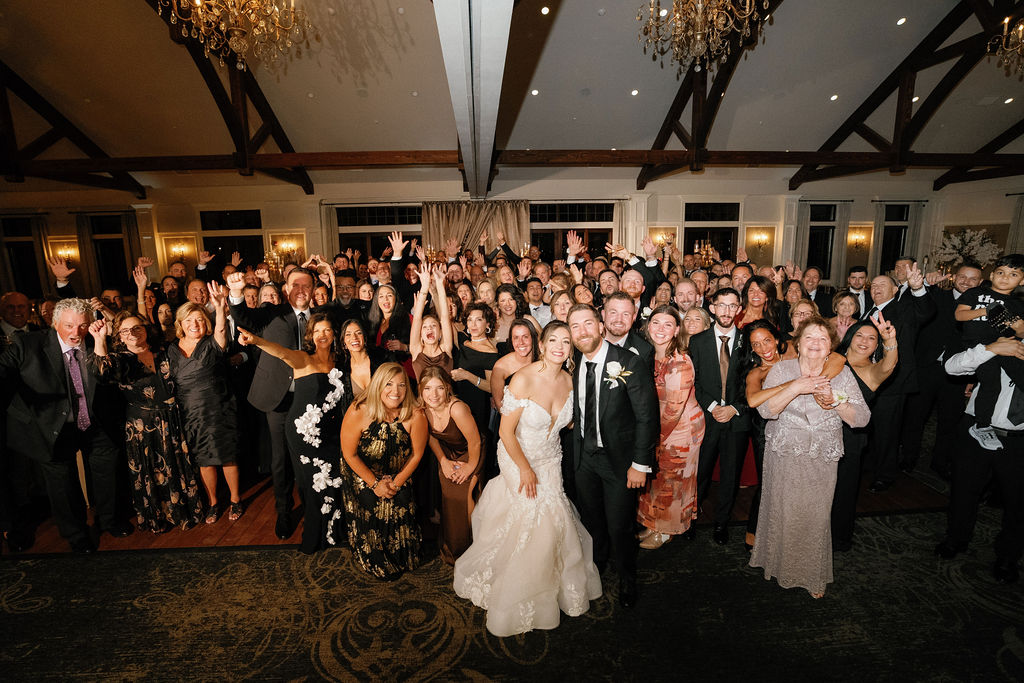 Packed dance floor at a Timber Banks Country Club wedding with vaulted timber ceilings, chandeliers and guests celebrating