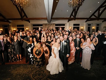 Packed dance floor with vaulted timber ceilings and chandeliers at a Timber Banks Country Club wedding