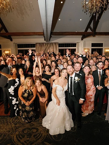 Packed dance floor with guests celebrating around the bride and groom at Timber Banks Country Club
