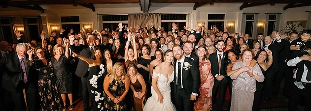Packed dance floor with vaulted timber ceilings and chandeliers at a Timber Banks Country Club wedding