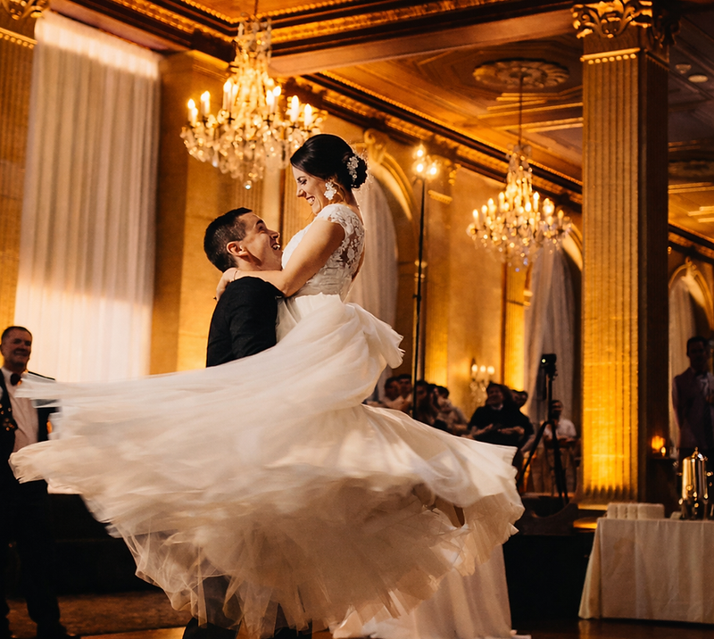 Couple dancing on clouds surrounded by cold sparks at a grand destination wedding