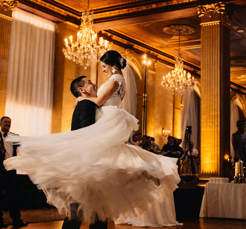 Couple dancing on clouds surrounded by cold sparks at a grand destination wedding
