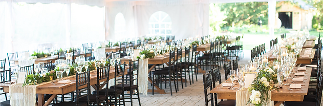 Elegant tented wedding reception at John Joseph Inn in Groton, near Ithaca with white draping, chandeliers, and string lights