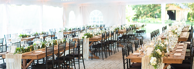 Elegant tented wedding reception at John Joseph Inn in Groton, near Ithaca with white draping, chandeliers, and string lights