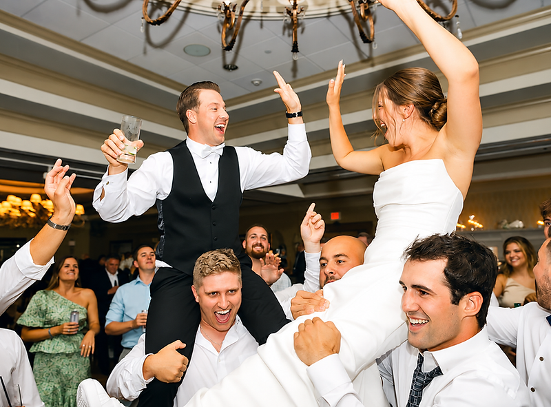 Newlyweds lifted on guests' shoulders during a HYBRID LIVE dance floor celebration
