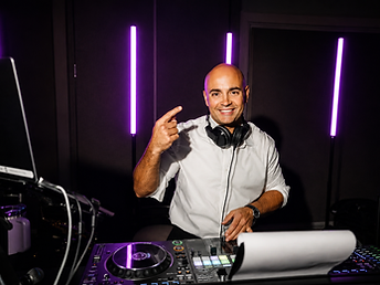 DJ Mike Melice smiling behind the controller at an event