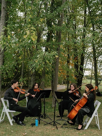 String quartet performing during Alexa and Dawson's outdoor wedding ceremony at Timber Banks Country Club