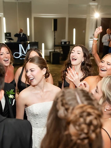 Bride laughing on a packed dance floor with guests at a Timber Banks Country Club wedding