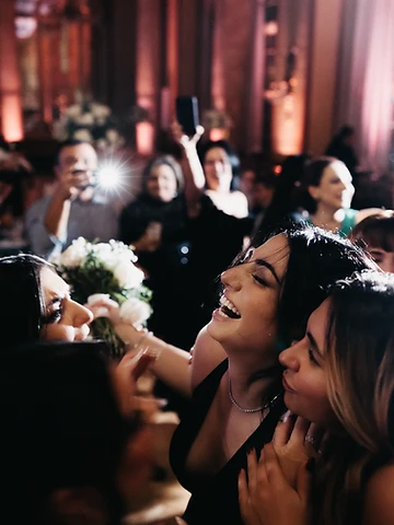 Guests laughing and celebrating together on the dance floor during Svetlana and Konstantin's reception