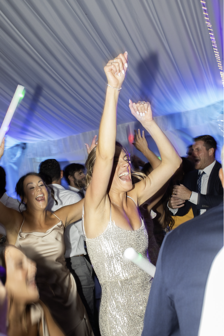 Bride in a silver sequined gown dancing during the reception at John Joseph Inn in Groton, near Ithaca