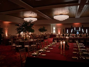 Architectural uplighting washing a banquet hall in blue during an event