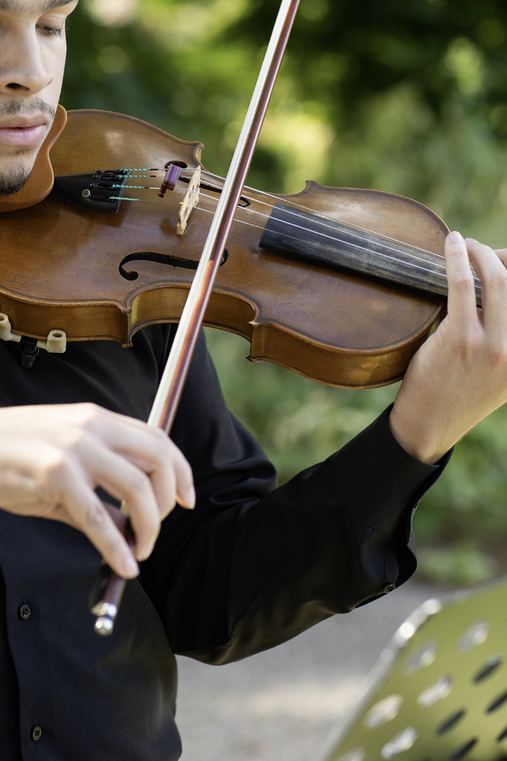 Live violinist performing during a wedding ceremony at John Joseph Inn in Groton, near Ithaca