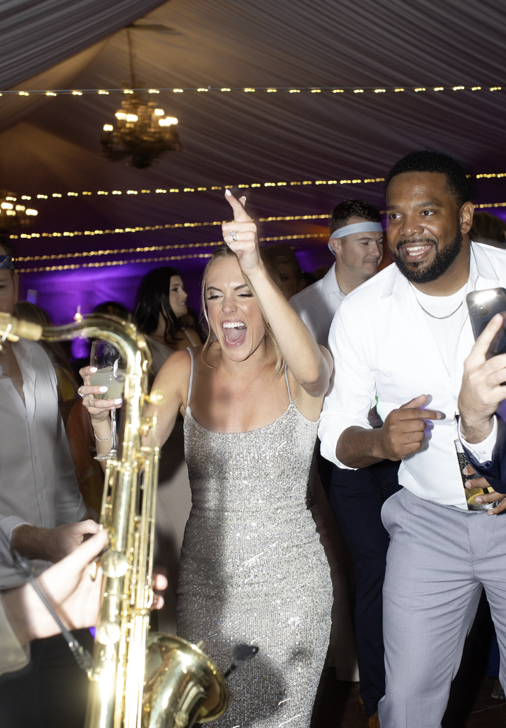Saxophonist performing on the dance floor while guests dance at John Joseph Inn in Groton, near Ithaca
