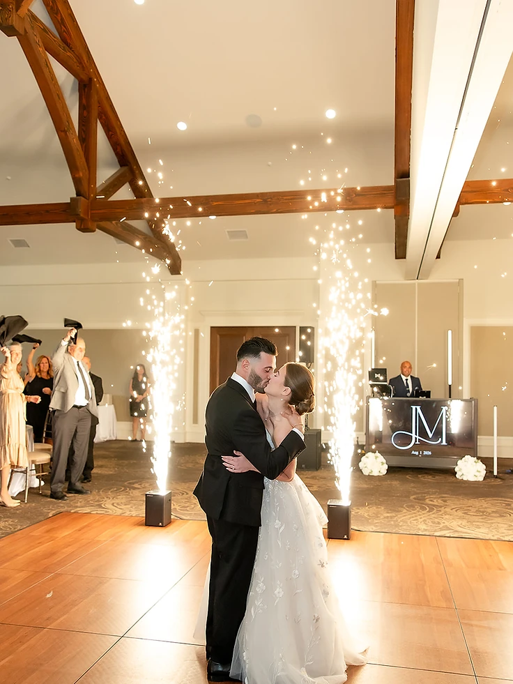 Bride and groom in a first dance framed by Cold Sparks at Timber Banks Country Club