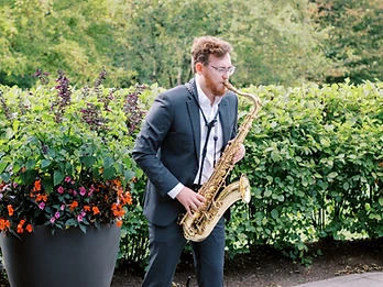 Live saxophone performance alongside the DJ at a private event