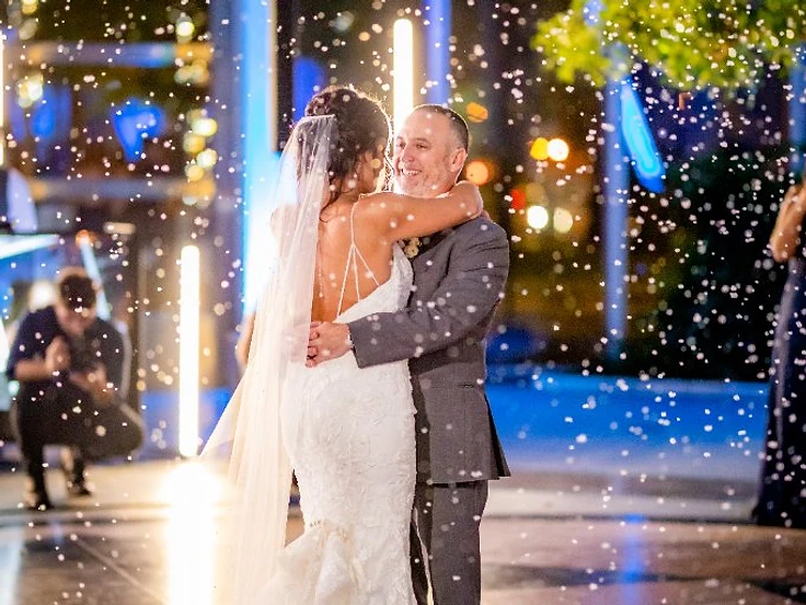 Couple dancing surrounded by falling indoor snow effect