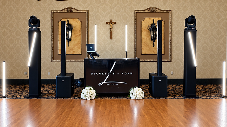 Personalized monogrammed DJ booth flanked by speaker towers, lighting trusses and vertical LED tubes at a Ventosa Vineyards wedding reception