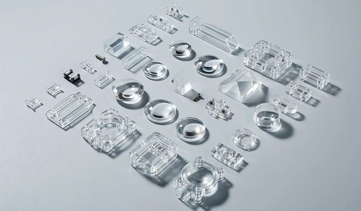 Transparent precision molded optical plastic components and technical clips