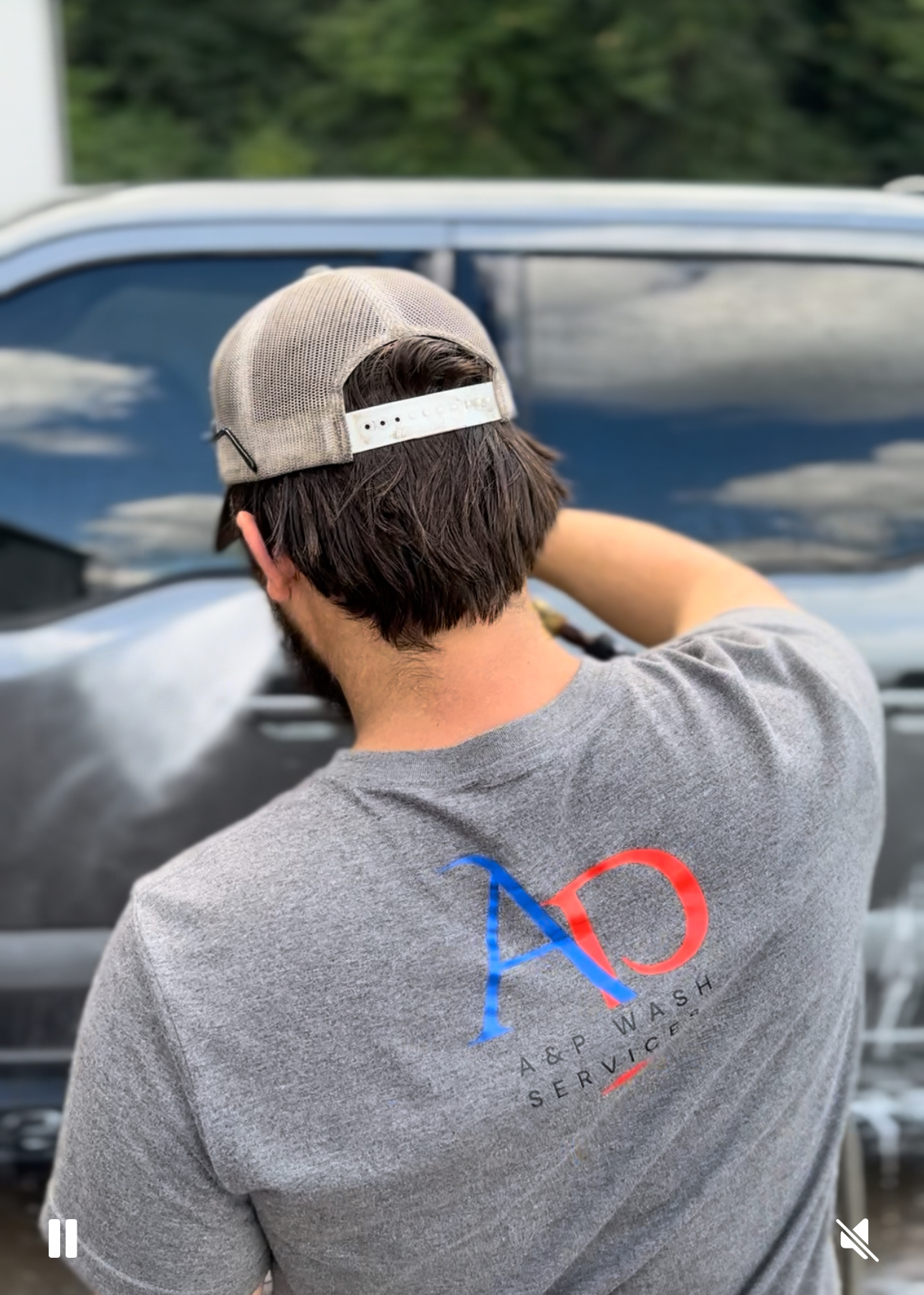 A&P Wash Services technician pressure washing a vehicle, branded shirt visible