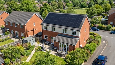 Modern UK house with a full array of black solar panels on a south-facing roof