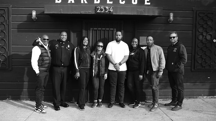 Volunteers and community members gathered in front of Horn Barbecue on giveaway day