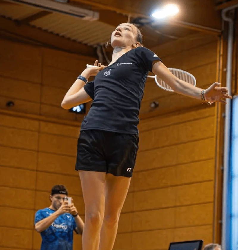 Joueuse du Volant des Dômes au smash lors d’une compétition de badminton