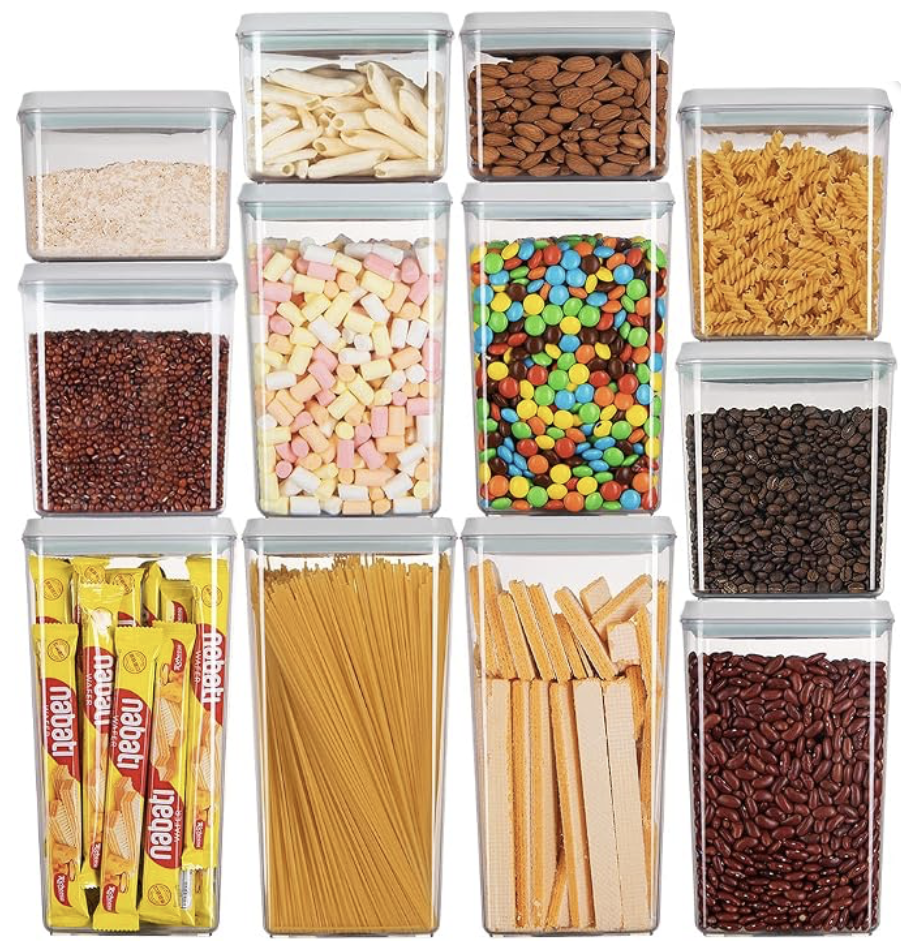 Set of clear airtight food storage canisters filled with pasta, nuts, and dry goods