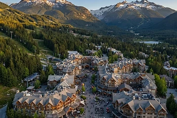 Whistler Village at golden hour with Whistler and Blackcomb mountains behind