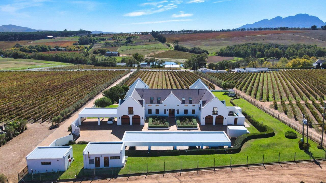 Cape Dutch farmhouse across the autumn vine rows