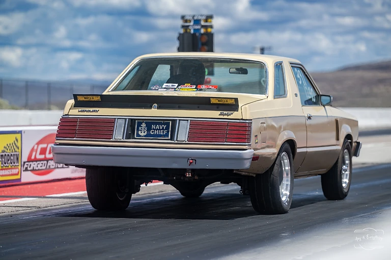 Track crew members and racers gathered beside the starting line at Top Gun Dragstrip