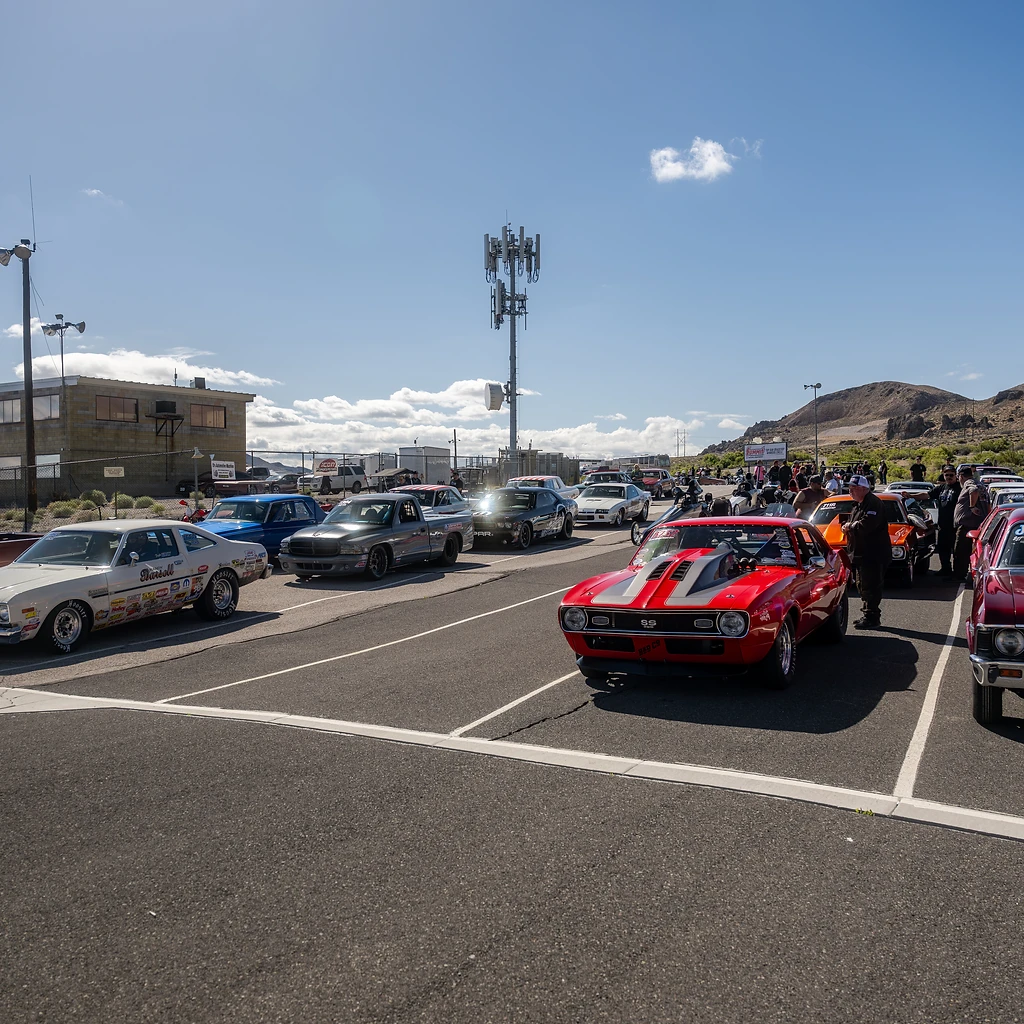 Race cars and crews assembled in the staging lanes at Top Gun Dragstrip