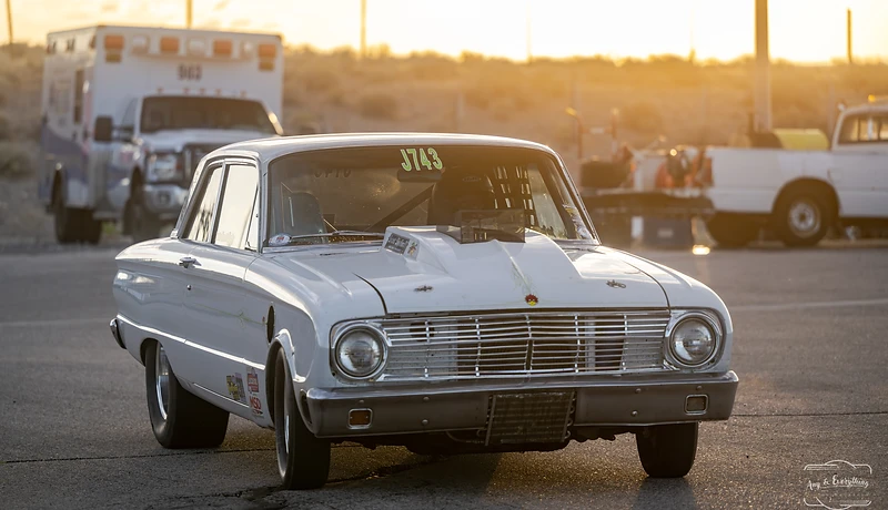 Race car silhouetted against a Fallon sunset at Top Gun Dragstrip